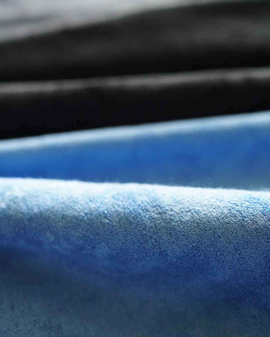 Close-up of the blue fabric texture with black reverse behind