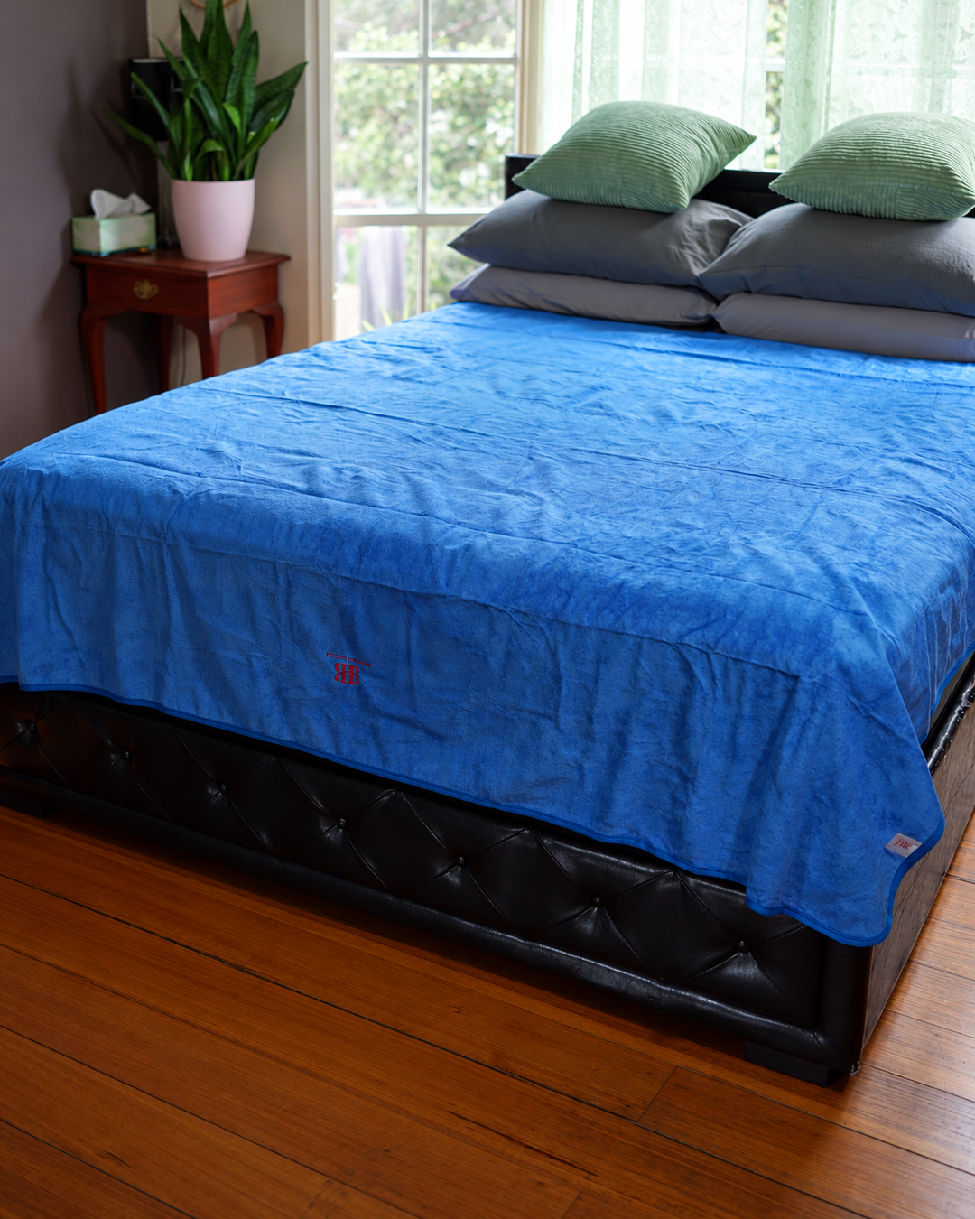 Capri Blue Luxury 2 × 2 m waterproof blanket spread flat across a bed