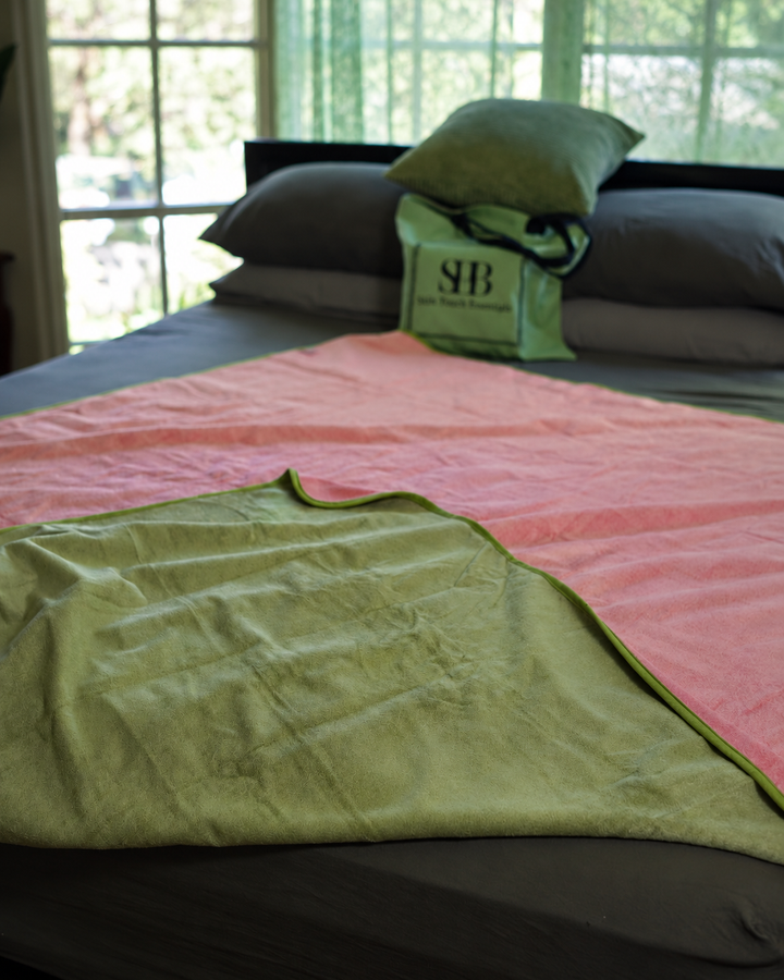 Close-up of Matcha Mist and Pink reversible blanket fabric and green edging