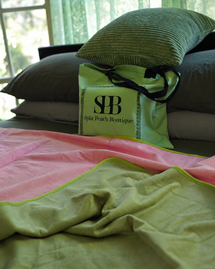 Soft folds of Matcha Mist and Pink bamboo and cotton fabric beside Split Peach branded bag