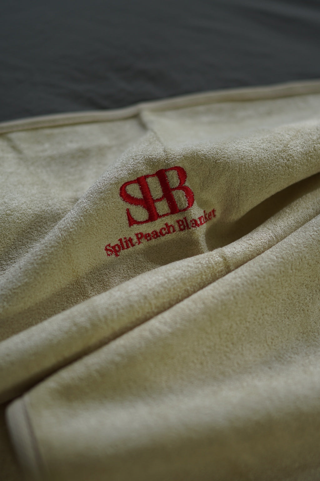 Close-up of Sand bamboo and cotton texture and embroidered logo