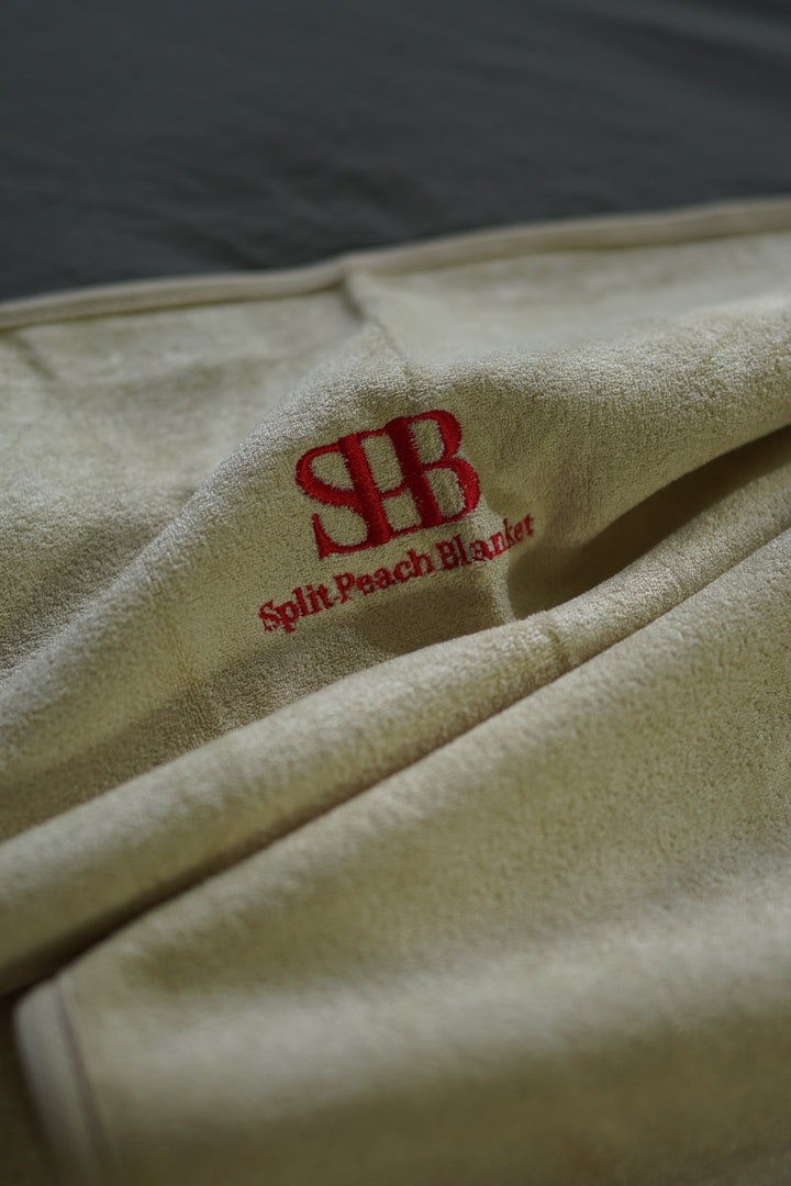 Close-up of Sand bamboo and cotton texture and embroidered logo